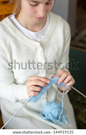 Young girl knitting, close up