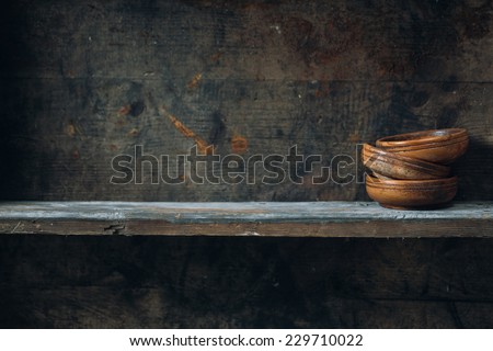 Old wooden bowls, placed on a wooden shelf