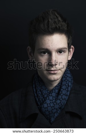 Young man in coat and scarf, portrait