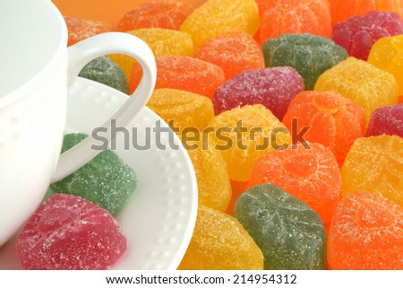 colorful candied fruit jelly and tea cup