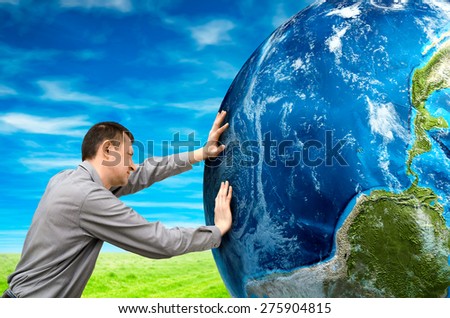 man pushes the planet. Elements of this image furnished by NASA
