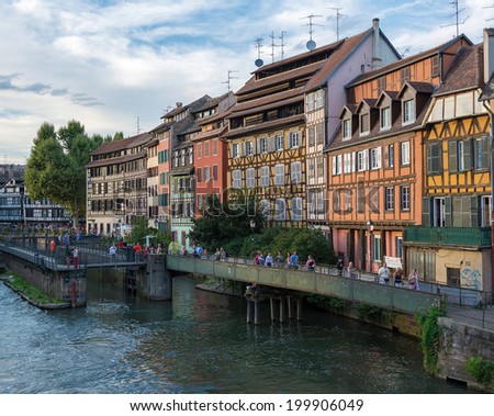 STRASBOURG, FRANCE - AUGUST 17, 2013: Tourists walking around Petite-France (Little France) in Strasbourg. Petite-France is an historic area in the center of Strasbourg.