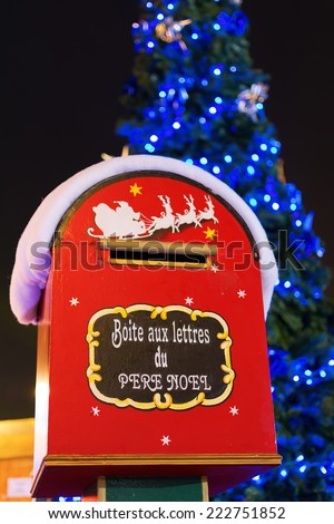 Christmas letter box to Santa with Christmas tree in the background in Paris, France