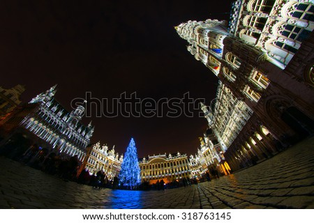Unique pavement-level perspective of gold-illuminated Grand Place, the focal point of Brussels, Belgium, at Christmas