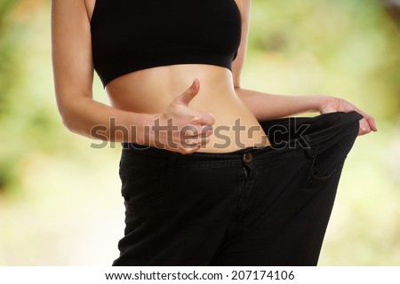 woman showing how much weight she lost