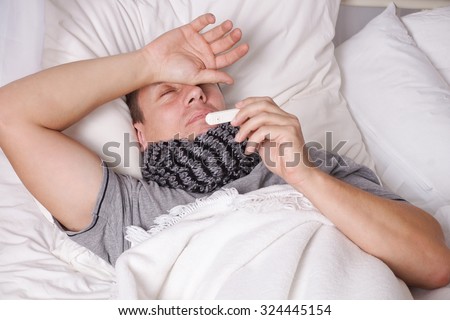 Man lying in bed with fever