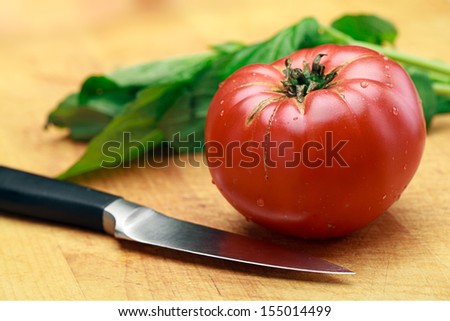 Tomato Basil and Knife On Cutting Board