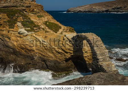 Scenic view to ancient bridge to small island near the town of Andros, Andros, Greece