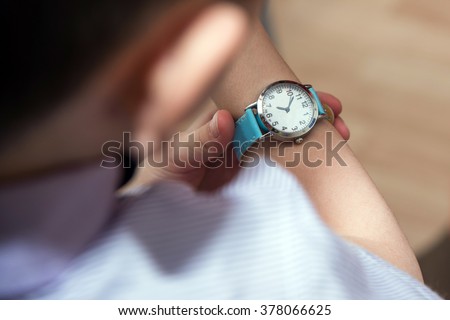 Boy looking at his wrist kid watch