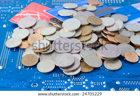 Technology business: money and credit cards on circuit board background