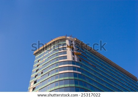 Finishing works on building construction on blue sky