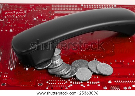 Get money after negotiations: coins and phone receiver on blue technological background