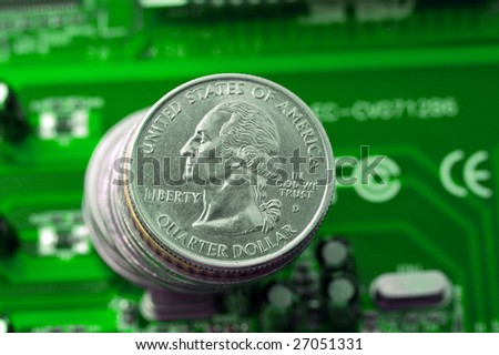 Make money on IT: quarter dollar coins over green microcircuit