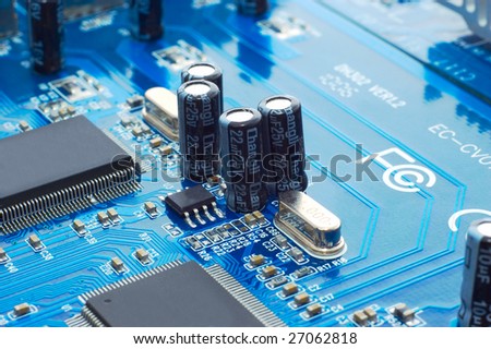 Technology: capacitors and chips on blue microcircuit board