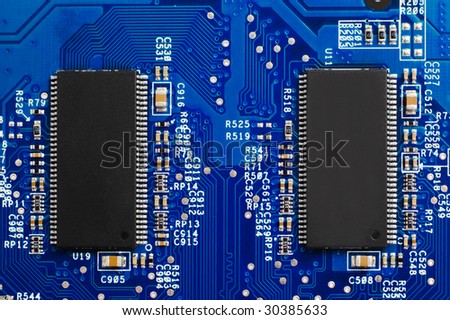 Power of technology: two chips on blue circuit board