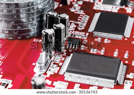 Make money using computer - concept made of circuit board and stack of coins