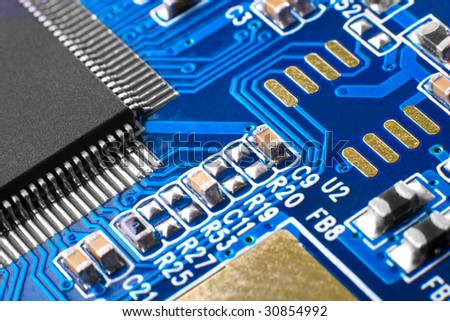 Open technology: capacitors and chips on blue microcircuit board
