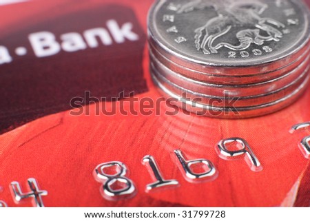 Financial issues: macro of coins stack on credit card. Focus on coin edge