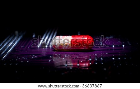 Medical research product - pill on circuit board in the dark