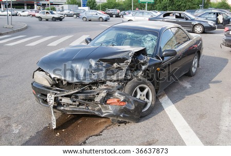 stock photo Wrecked car in the city traffic background