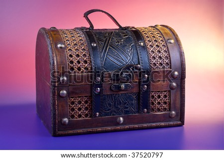 Old wooden chest for treasure on color background