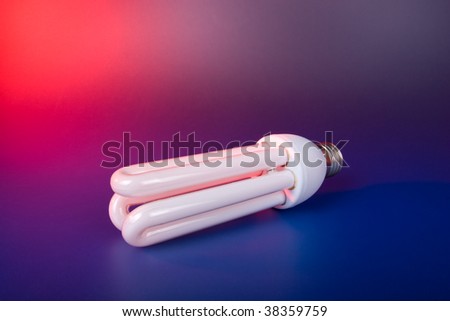 Energy efficient light bulb on red and blue background