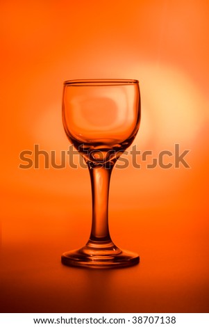 Hot party - wine glass on bright, vivid orange background
