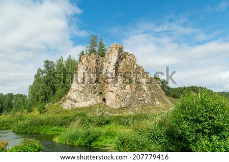 Rock on the bank of a stream in the summer, Russia, Ural Mountains