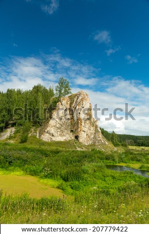Rock on the bank of a stream in the summer, Russia, Ural Mountains