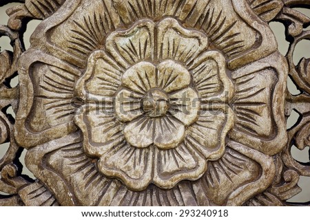 Close up of wooden carved panel with rose design, common in Thai decorative design