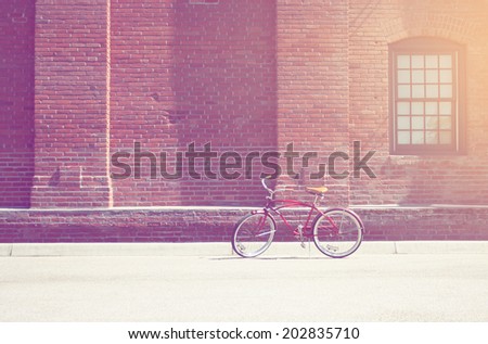 classic bike with brick building background with instagram filter