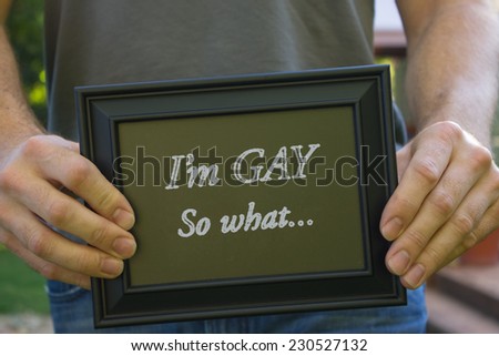 Male holding picture frame with title of \