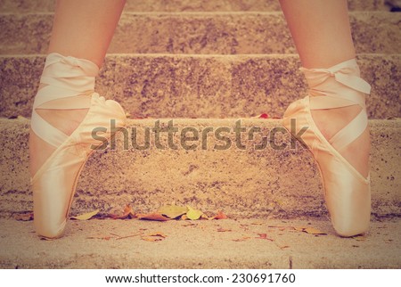 Woman ballet shoes on pointe on cement steps with retro instagram filter (shallow depth of field)
