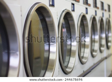 laundromat machine washer line with closed doors (shallow depth of field)