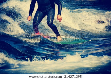 male surfer riding a wave on a white water river park with a retro vintage instagram filter