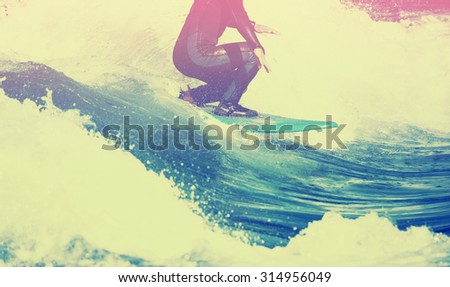 male surfer riding a wave on a white water river park with a toned vintage instagram filter