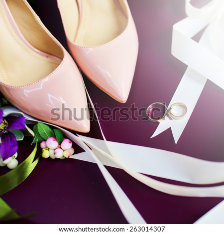 Wedding rings , bouquet and pink shoes composition. Marriage  mood. Morning bride.  Groom\'s boutonniere.Square composition.