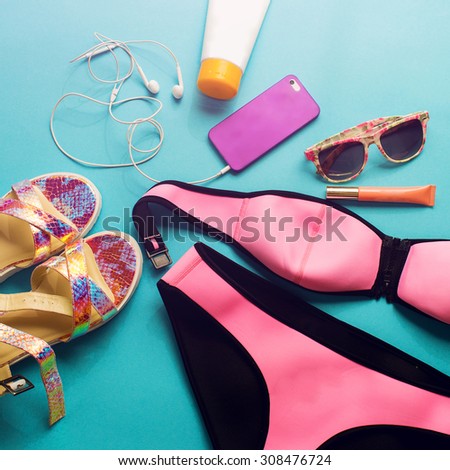 Top view of summer accessories for modern  stylish girl. Beach fashion set.Overhead of essentials for  young person. Neon shoes and bright colors.