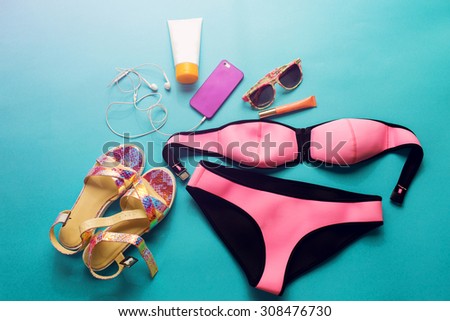 Top view of summer accessories for modern  stylish girl. Beach fashion set.Overhead of essentials for  young person.