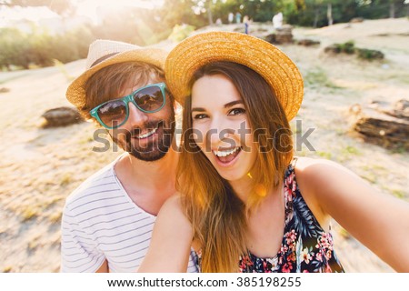 Happy traveling couple  making selfie  mountains  background , sunny summer colors, romantic mood. Stylish sunglasses, straw hat. Happy laughing  emotional faces.