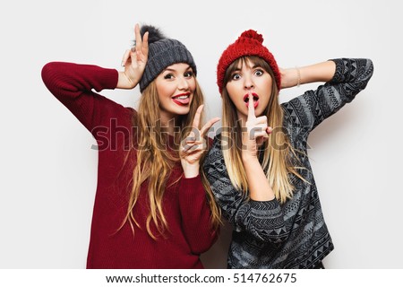 Lifestyle positive  emotional  image of two best friends , surprise face, show tongue, signs, going crazy  on white background.
