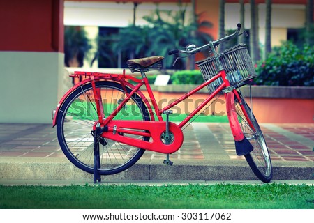 It is Parking red bicycle with basket for pattern.