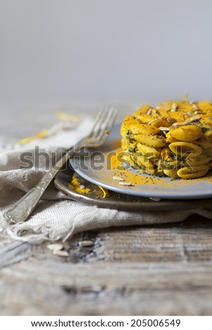 summer flowers pasta with seeds and petals flowers and yellow spices on rustic background