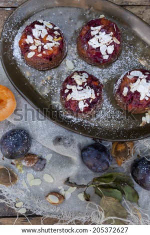 fruits vegan cupcakes with apricots and prunes on rustic table with jute napkin