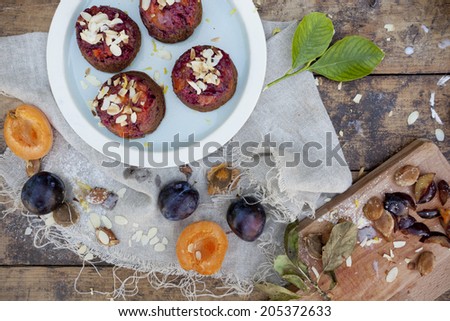 fruits vegan cupcakes with apricots and prunes on rustic table with jute napkin