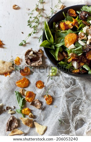 alternative vegan salad with rocket, carrots chips, walnuts and seeds in japanese bowl