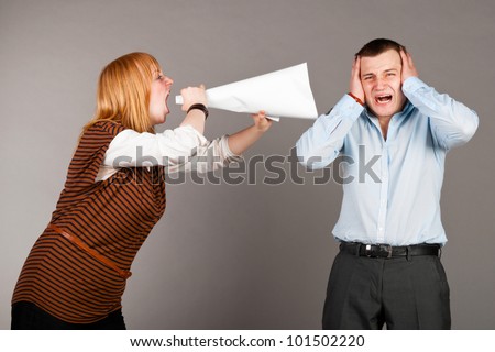 business woman is screaming to her associate with megaphone