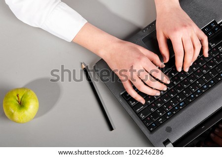 female hands are working on modern laptop, view from above