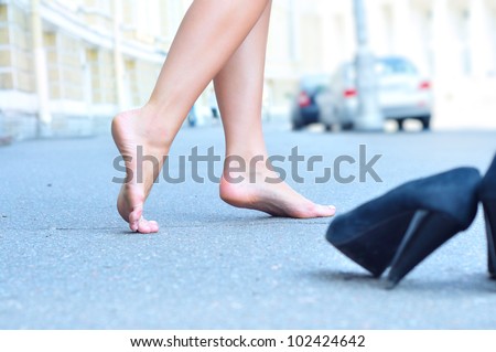 female bare feet dancing on summer street