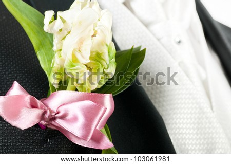 closeup view of flower on groom suit